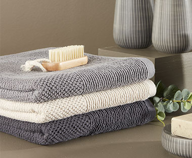 100% cotton hand towel available in beige, grey and asphalt