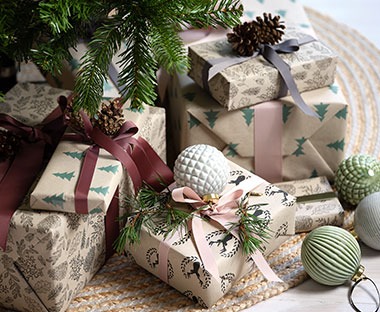 Recycled Christmas wrapping paper with green and white Christmas baubles
