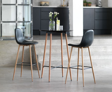 Black/oak bar table and two faux leather bar stools with wooden legs