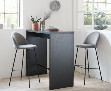 Grey velvet bar stools with black high table
