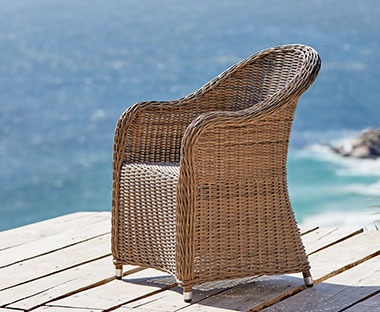 Grey lounge chair made of polyrattan
