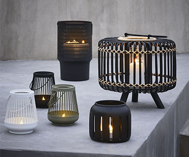 Multiple outdoor lamps and lanterns in a range of different designs and colours