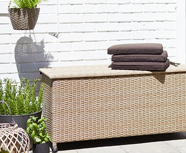 Steel and Polyrattan outdoor storage and cushion box with easy open lid in natural colour