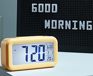 yellow digital alarm clock with several functions