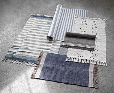 Multiple rugs in white, blue, black and beige