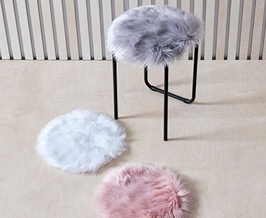 Fluffy fake fur chair cushions available in rose, off-white and grey