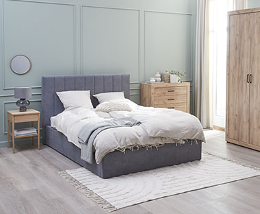 Light airy bedroom with bedroom accessories including pillows and duvet