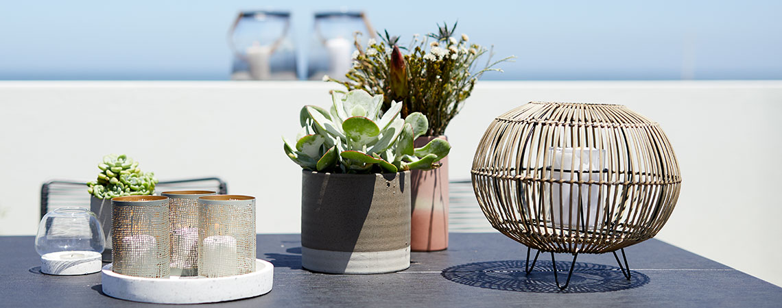 Create a beautiful sanctuary with woven balcony planters and garden lanterns 