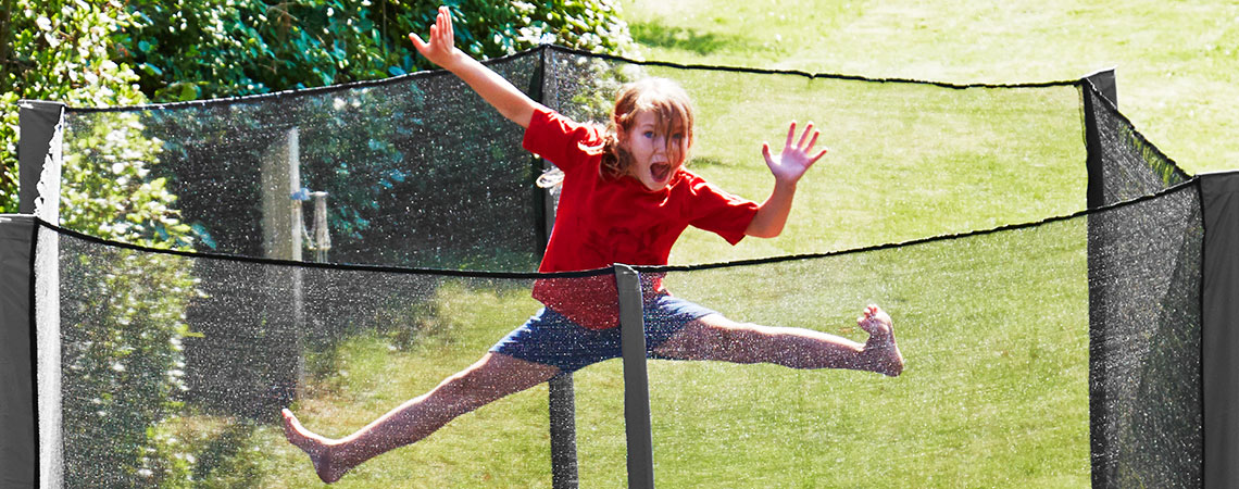 Girl jumping and having fun on a trampoline