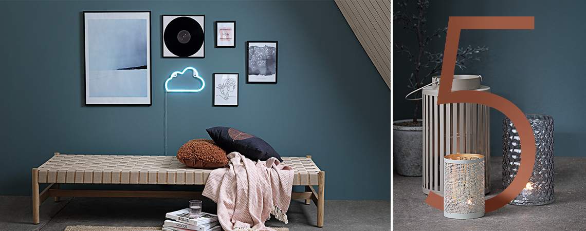 Daybed with cushions and a throw against a wall with posters and a cloud shaped lamp