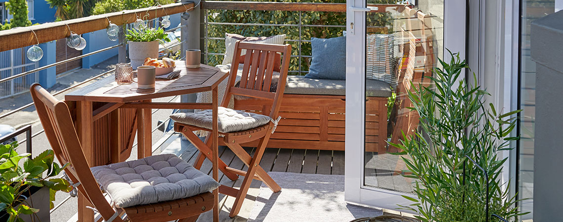 Wooden garden bistro set and outside storage box on balcony 