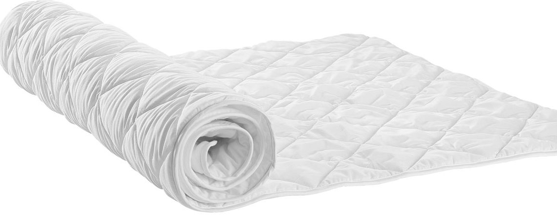 White mattress pad partially unrolled