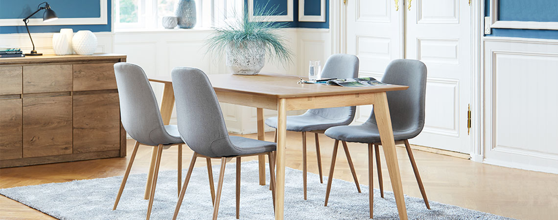 Oak dining table and grey dining chairs in a classy dining room