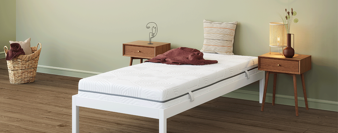 Single bed with white bed frame and mattress and two bed side tables