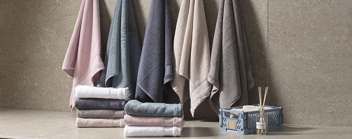 Towels in different colours hanging in a bathroom