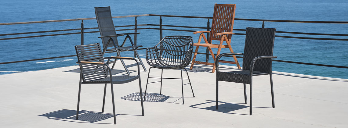 5 different garden chairs on patio overlooking the ocean