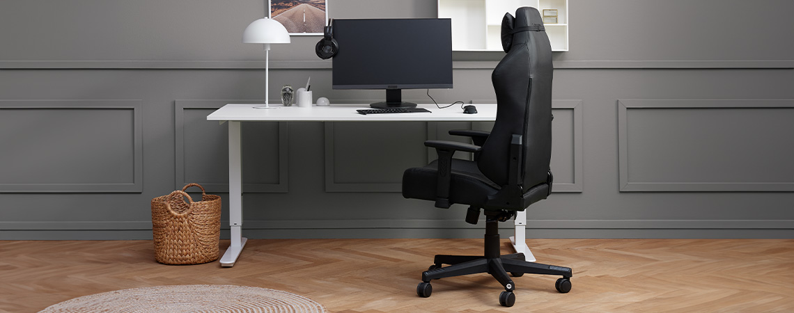 Stylish, sleek and ergonomic gaming chair by a desk with monitor and headset