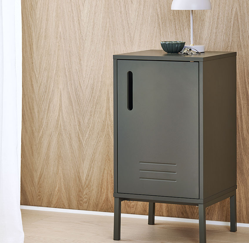 Small furniture cabinet in olive green with battery-operated lamp 