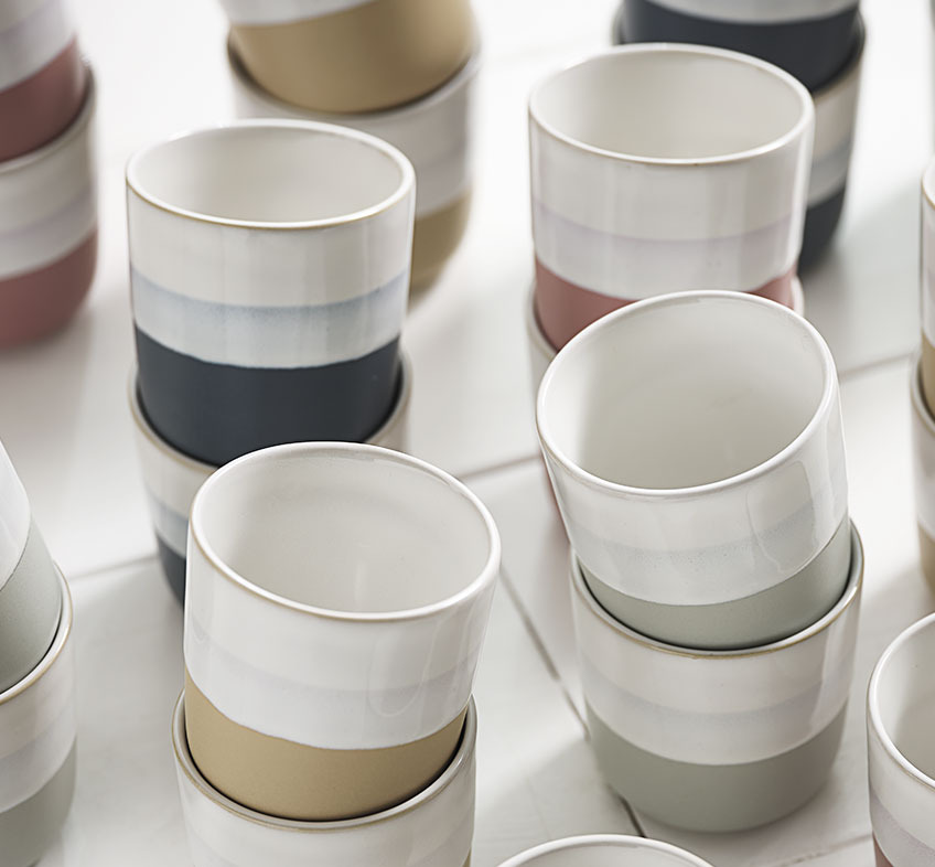 Porcelain mug with bands of different colour in various shades 