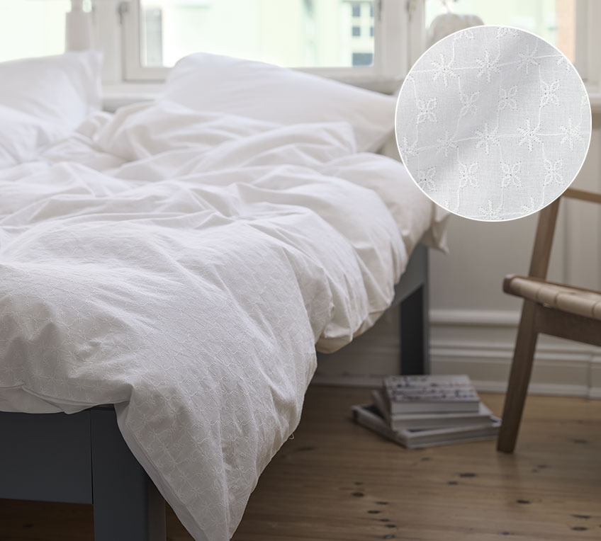 BIBI has French embroidery on the front and is plain on the back Bed with duvets and pillows in white bed linen