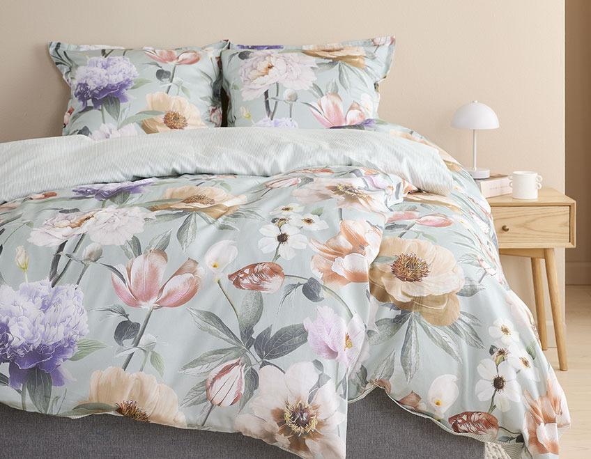 Floral bed linen in a light bedroom 