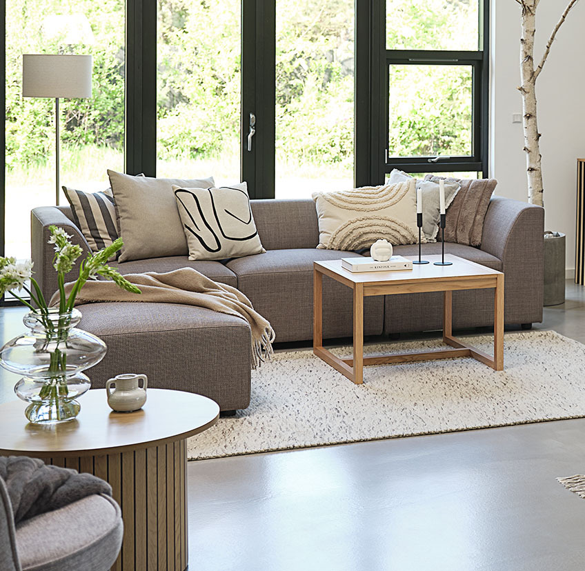 The RY oak coffee table comes in two sizes Minimalistic oak coffee table in bright living room with large sofa and decorative cushions