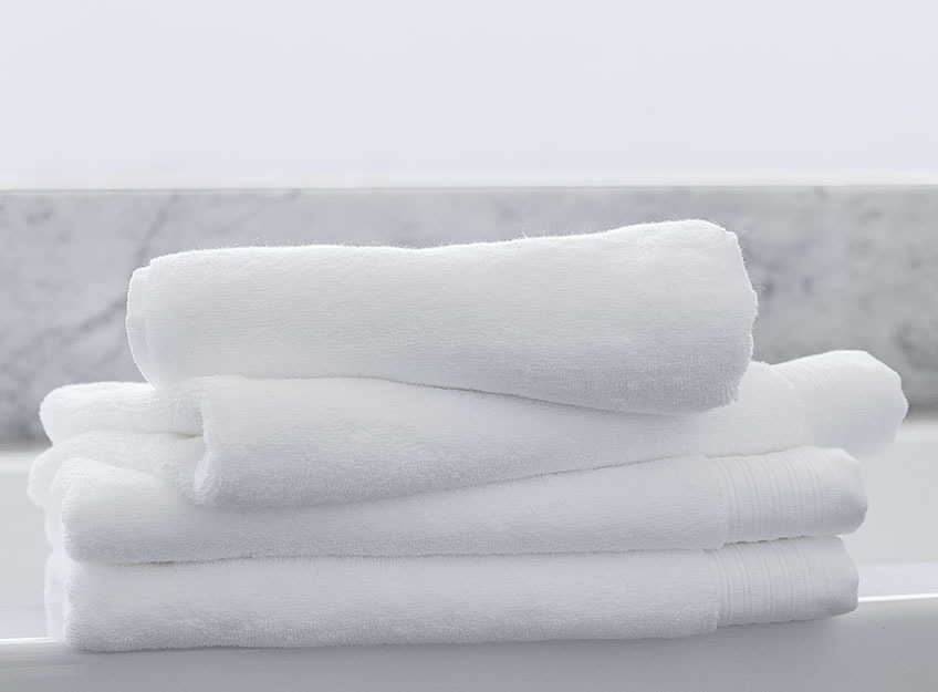 White towels in a stack in a bathroom