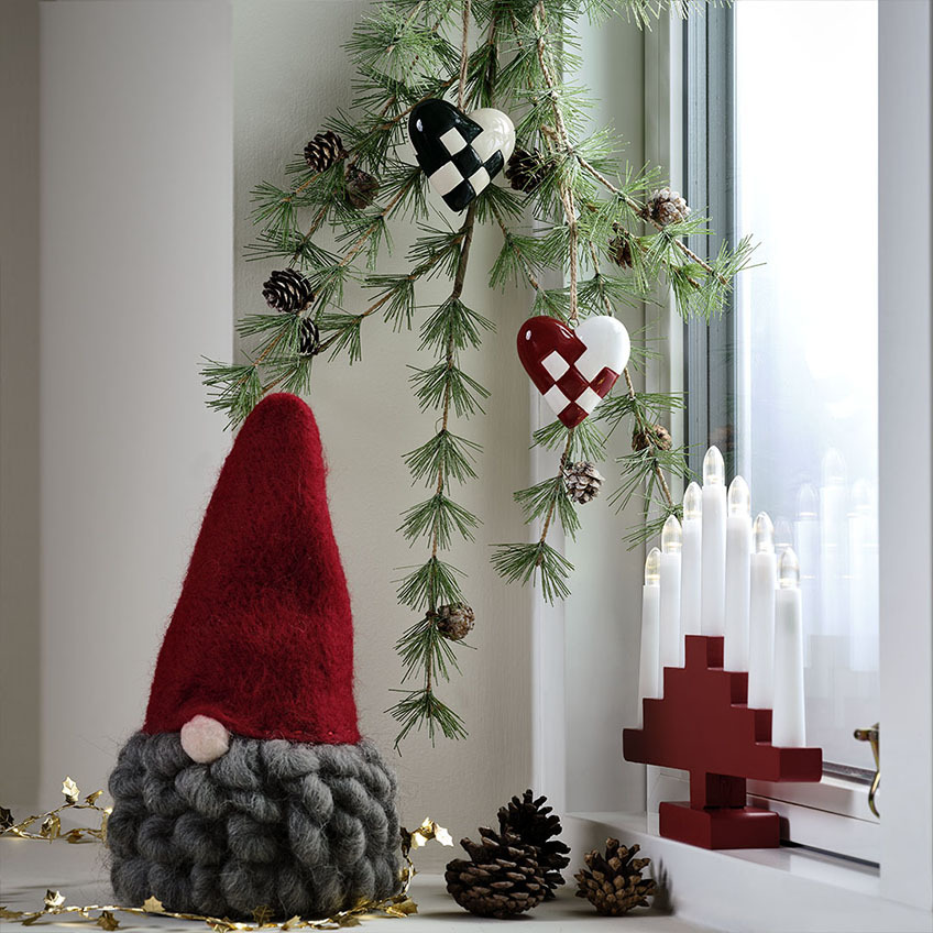 MUGGLESTEN Christmas elf and HILDEGUN candle arch Christmas gnome with a red gnome hat and grey beard, red candle arch, and artificial fir twig