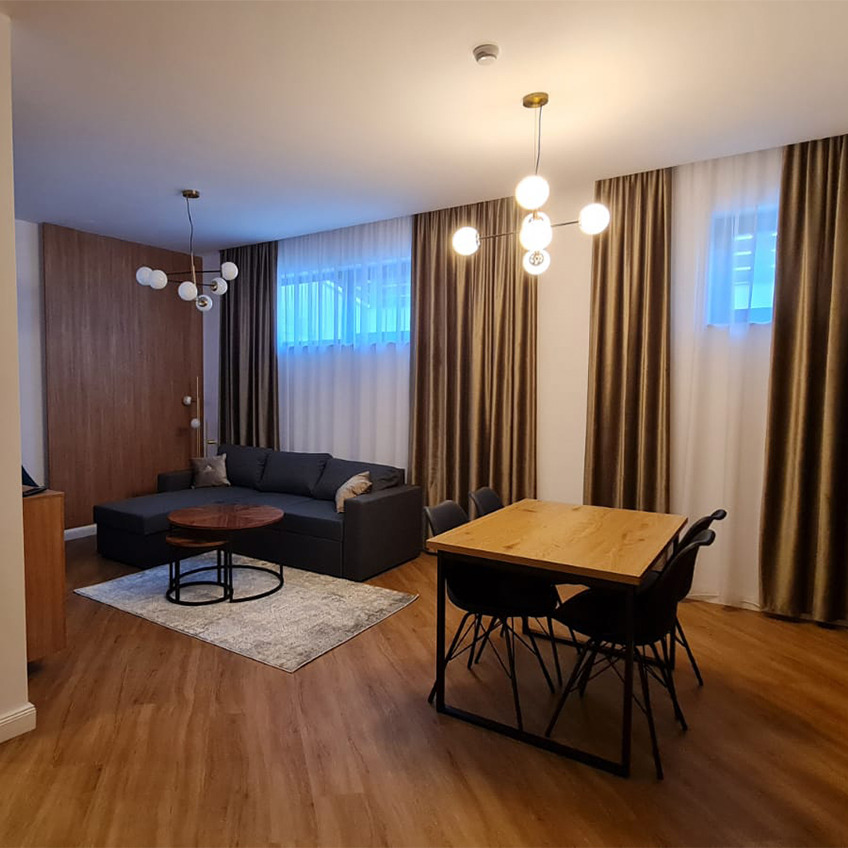 AABENRAA dining table, KLARUP dining chairs, and MARSLEV couch Furnished living room with table, couch, and decorations