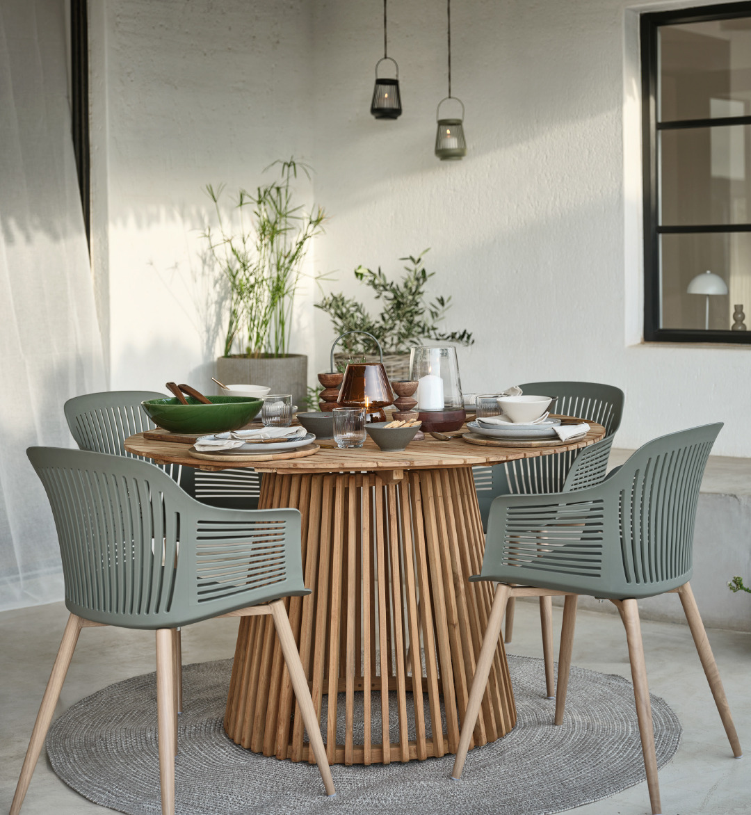 Wooden garden table with green chairs