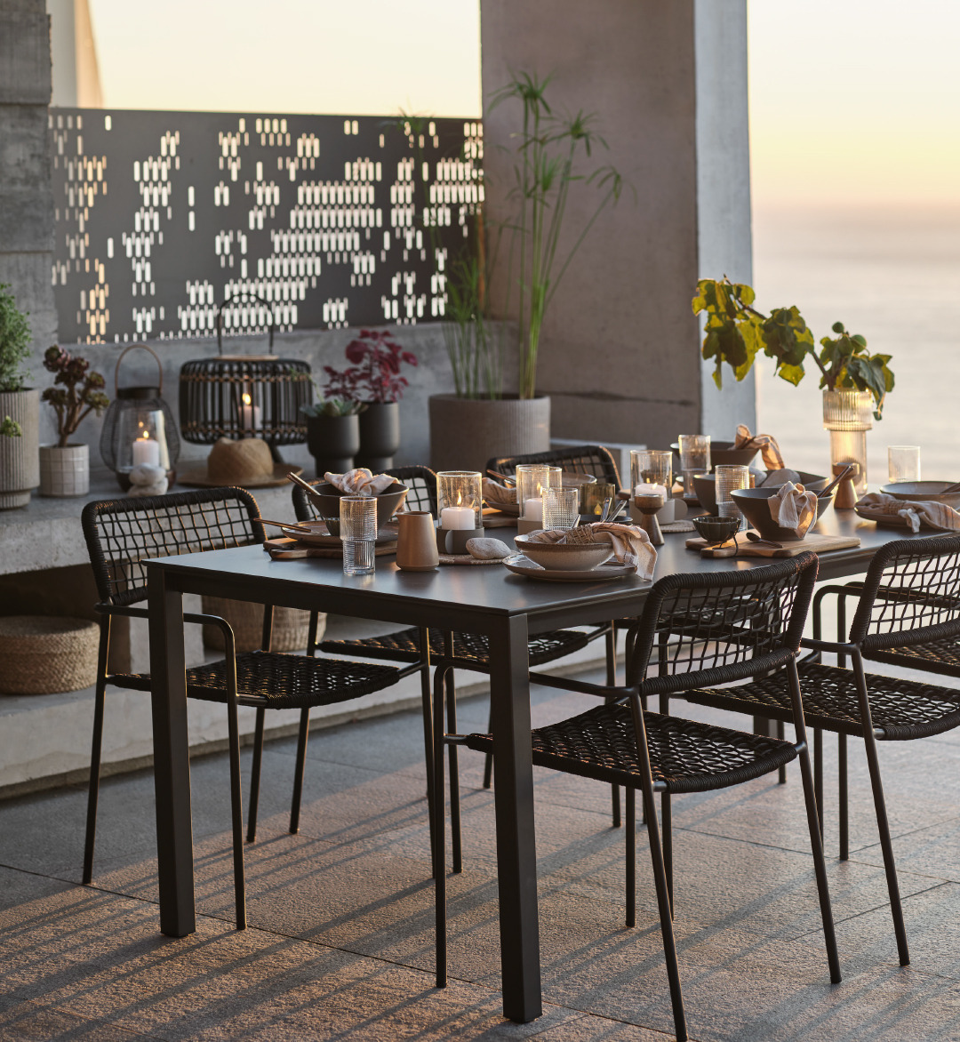 Black outdoor dining table with cutlery set