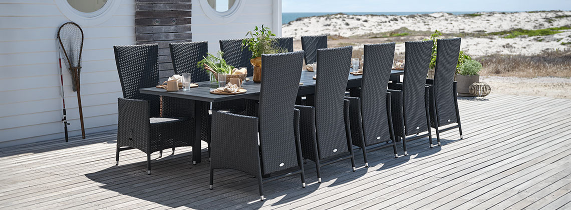 Large garden table and chairs for 10 or 12 people on patio by the beach 