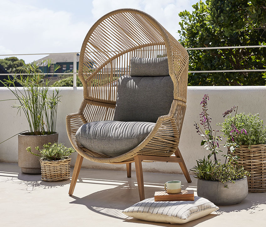 Large lounge chair on a sunny balcony 