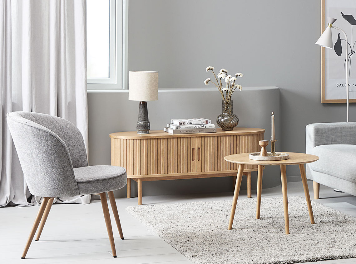 Light-coloured TV console table in living room