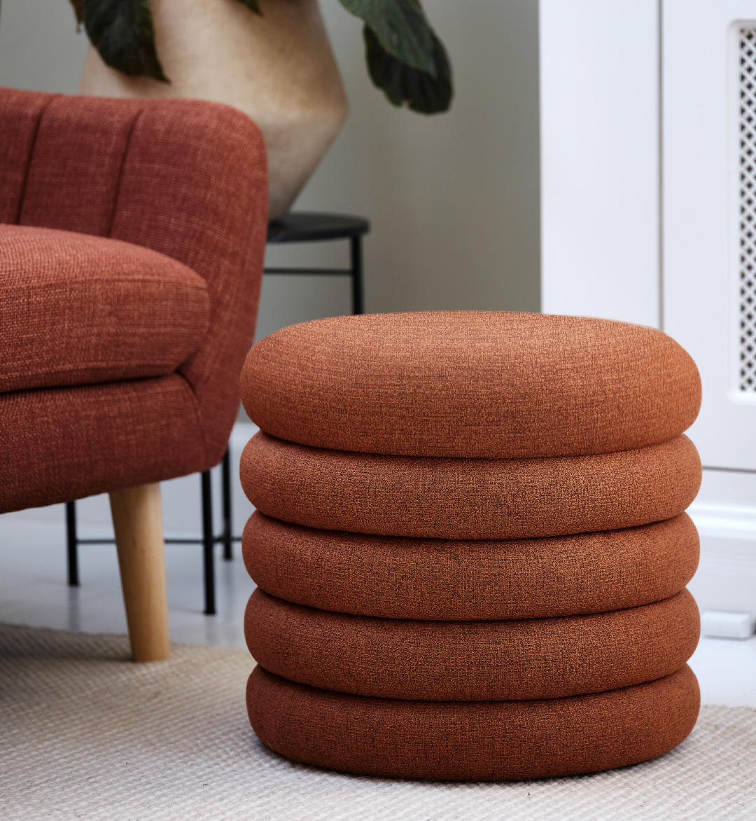 Close up of terracotta sofa and pouffe