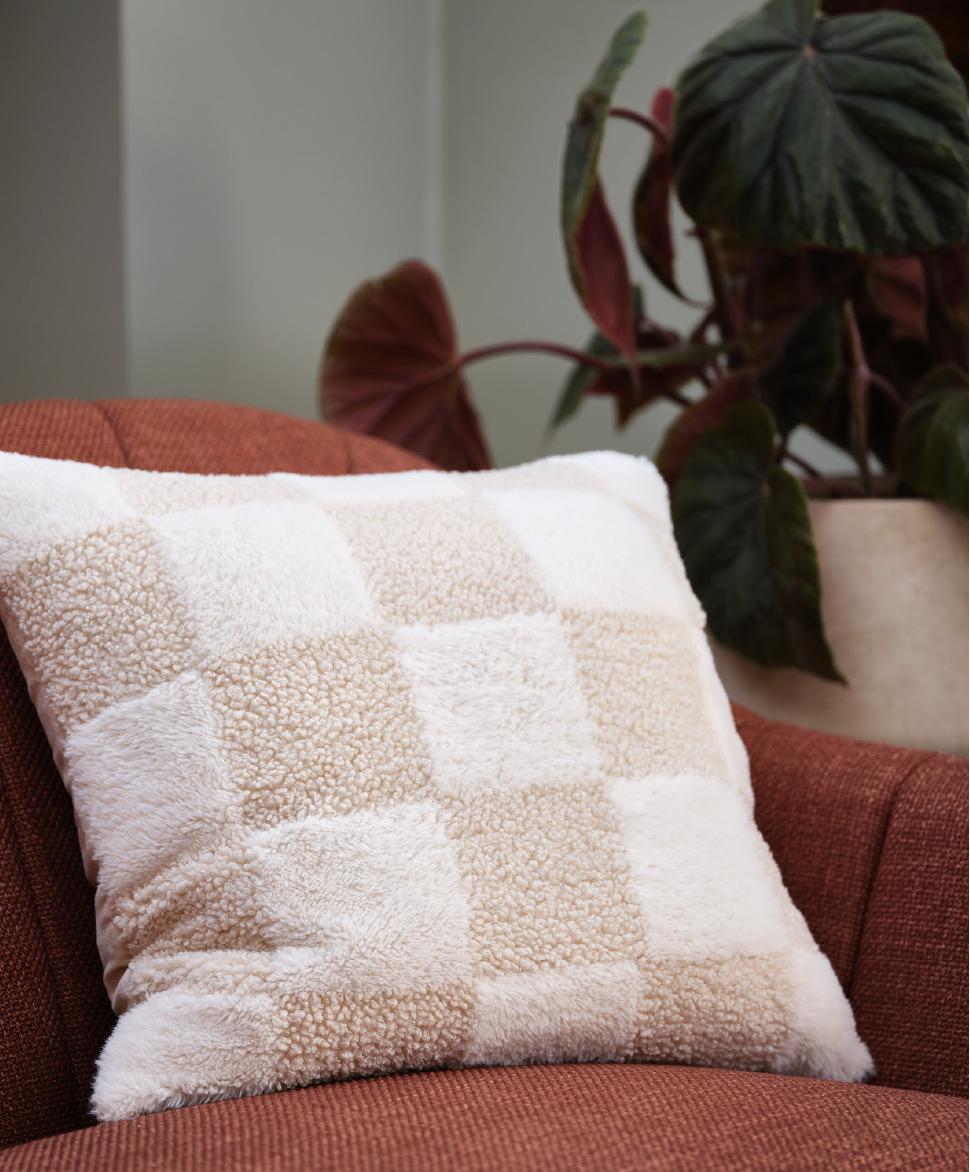 Beige checkered cushion on terracotta sofa