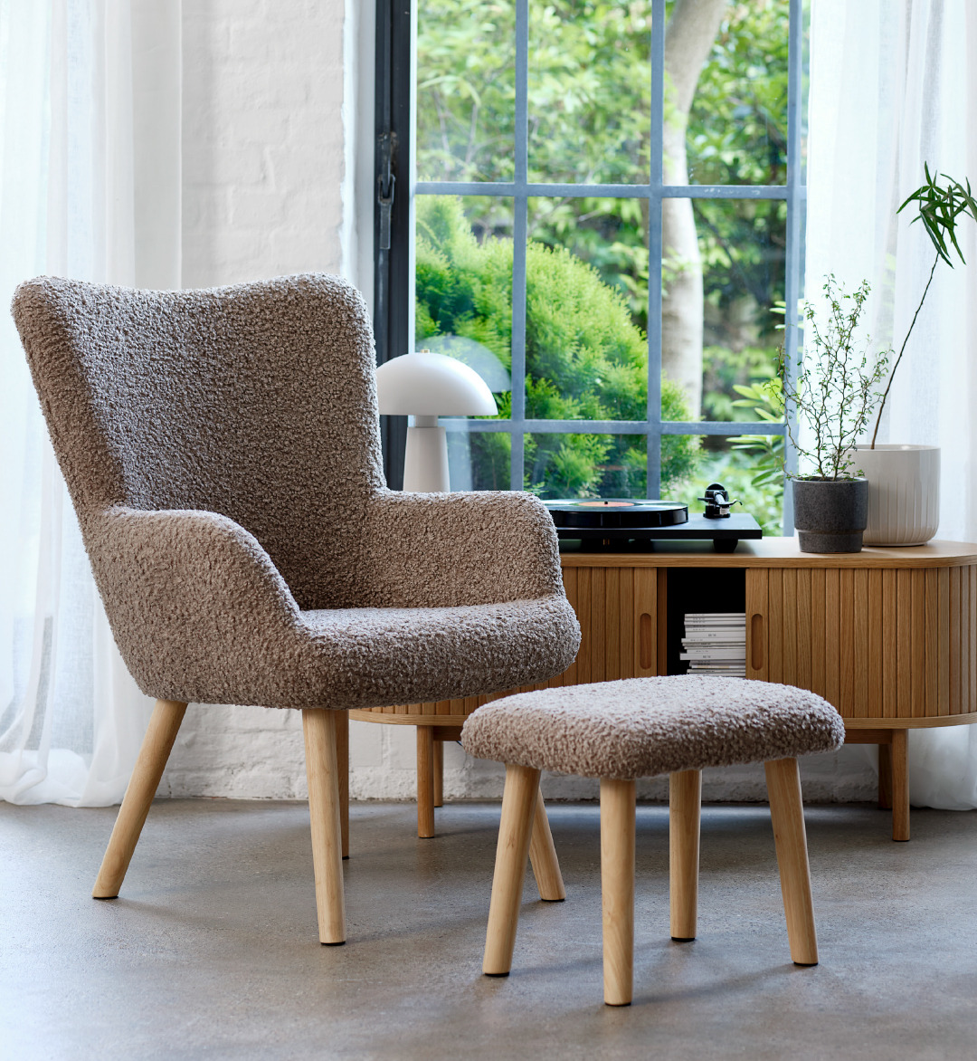 A sand teddy natural coloured armchair with foot rest