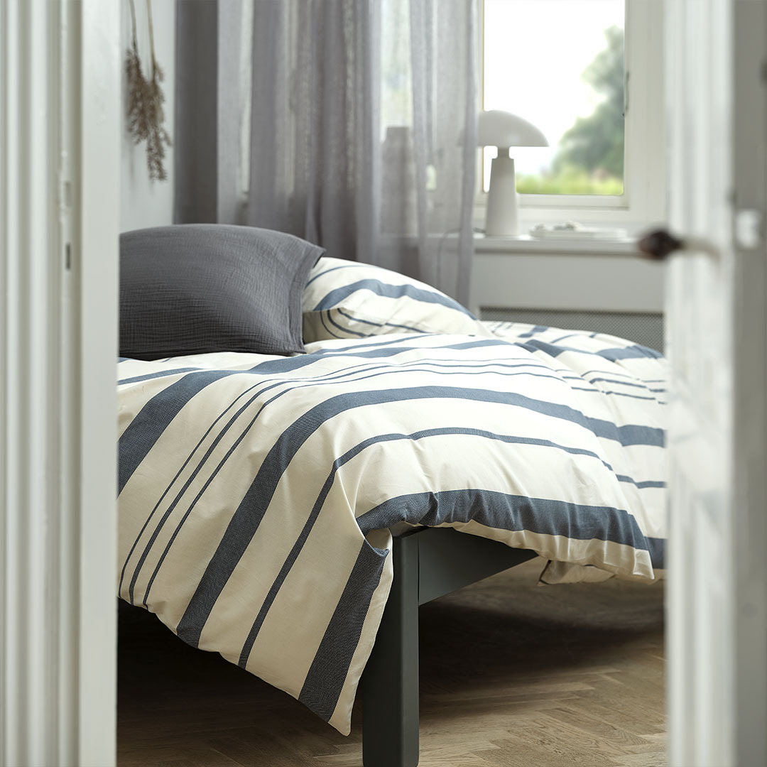 Blue and white striped duvet cover set in bedroom