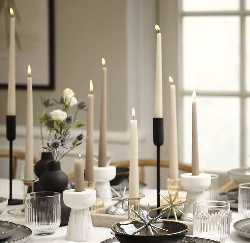 Candlesticks, candles and decoration on a New Year’s table 