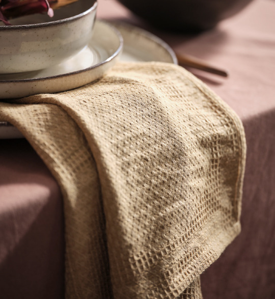 Tea towel hanging off of a dinner table and plates