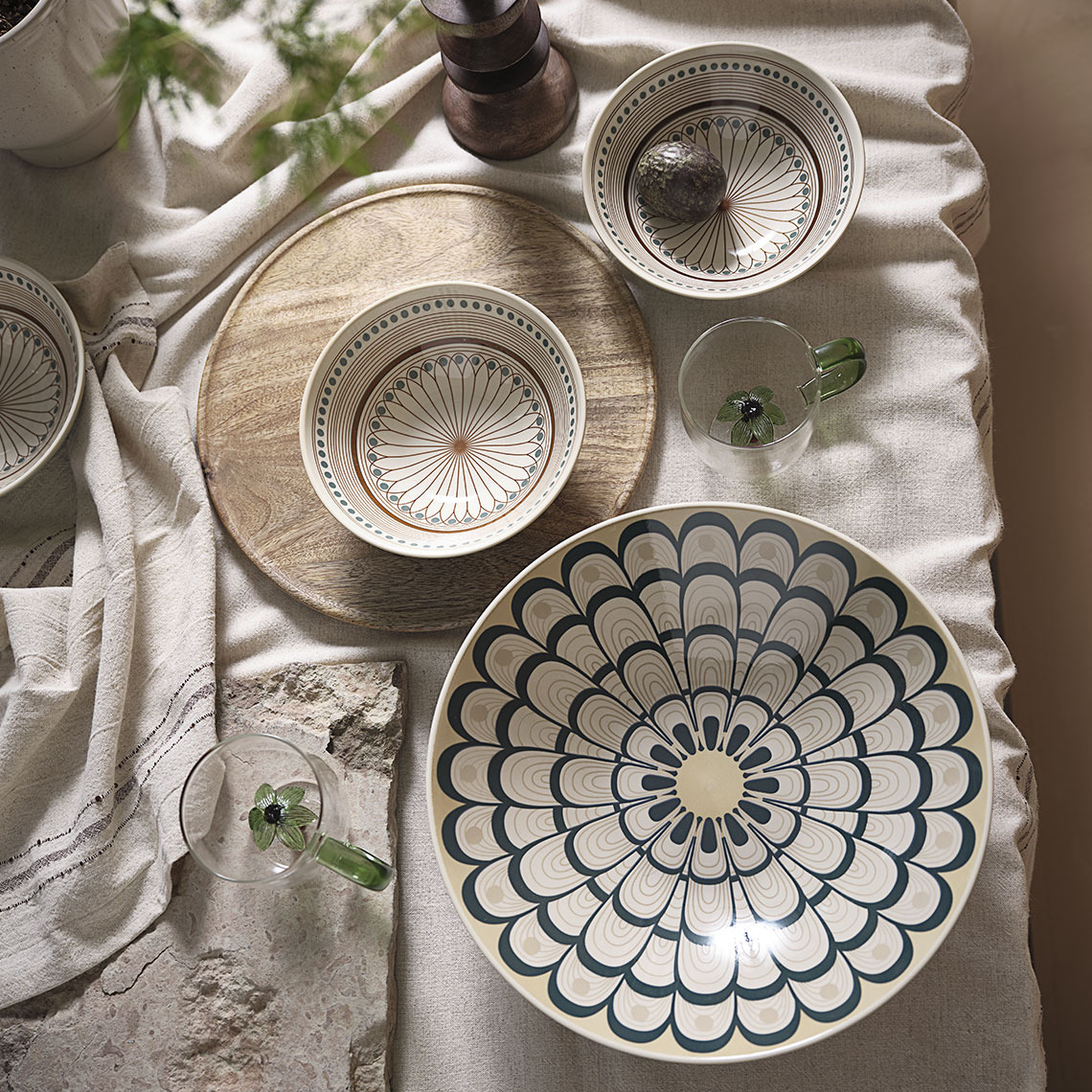 Table with tablecloth, mugs and bowls 