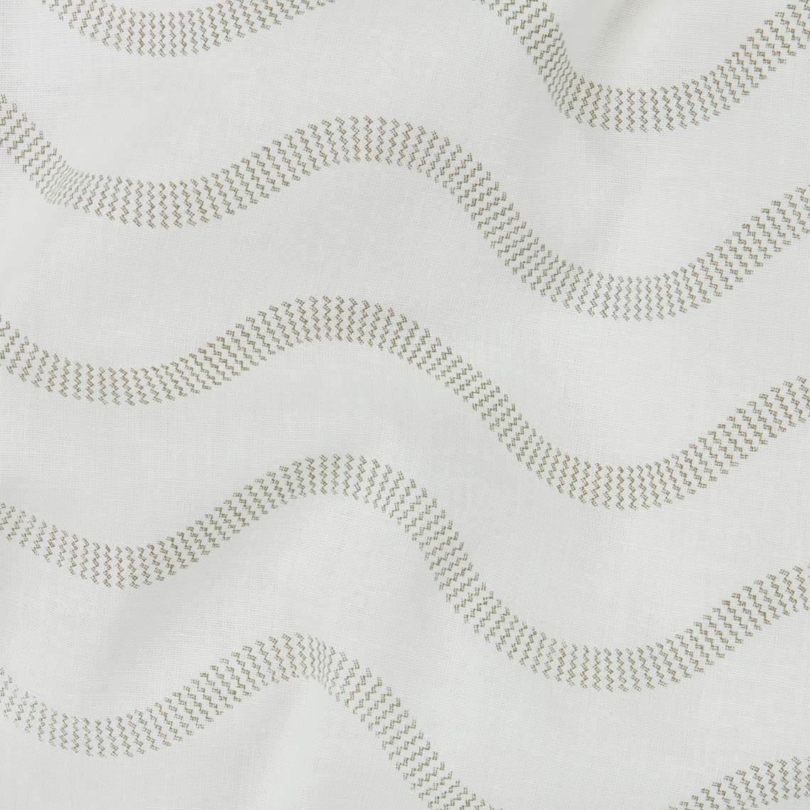 Closeup of white cotton bedding with wave pattern in olive green