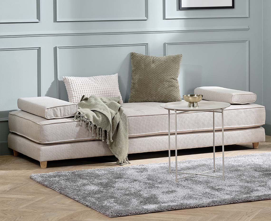 Beige daybed with armrest cushions