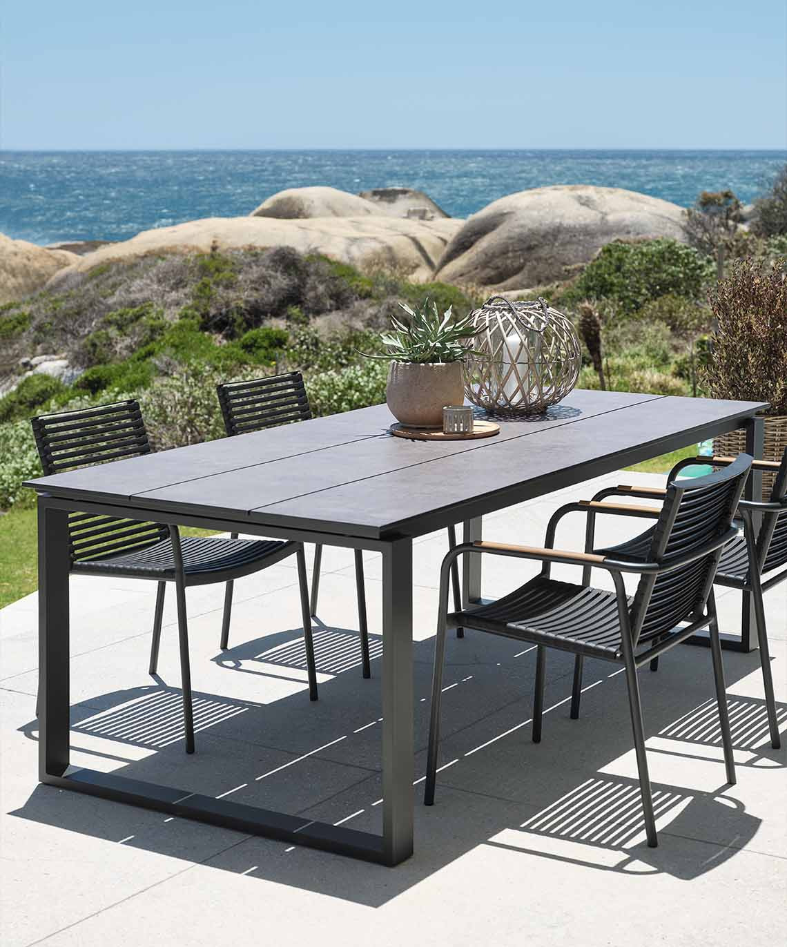 Large garden table and chairs on patio by the sea