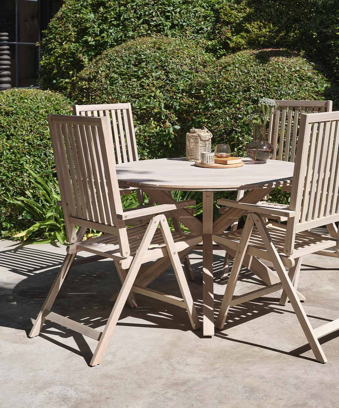 Outdoor table and four garden reclining chairs made from solid acacia wood 