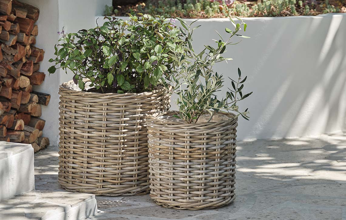 Woven rattan garden planters on deck