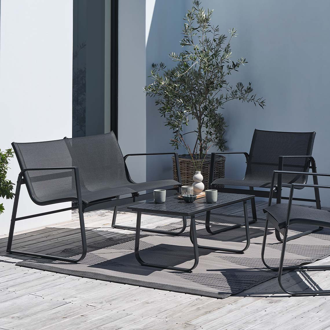 Maintenance-free garden lounge set in black on patio 