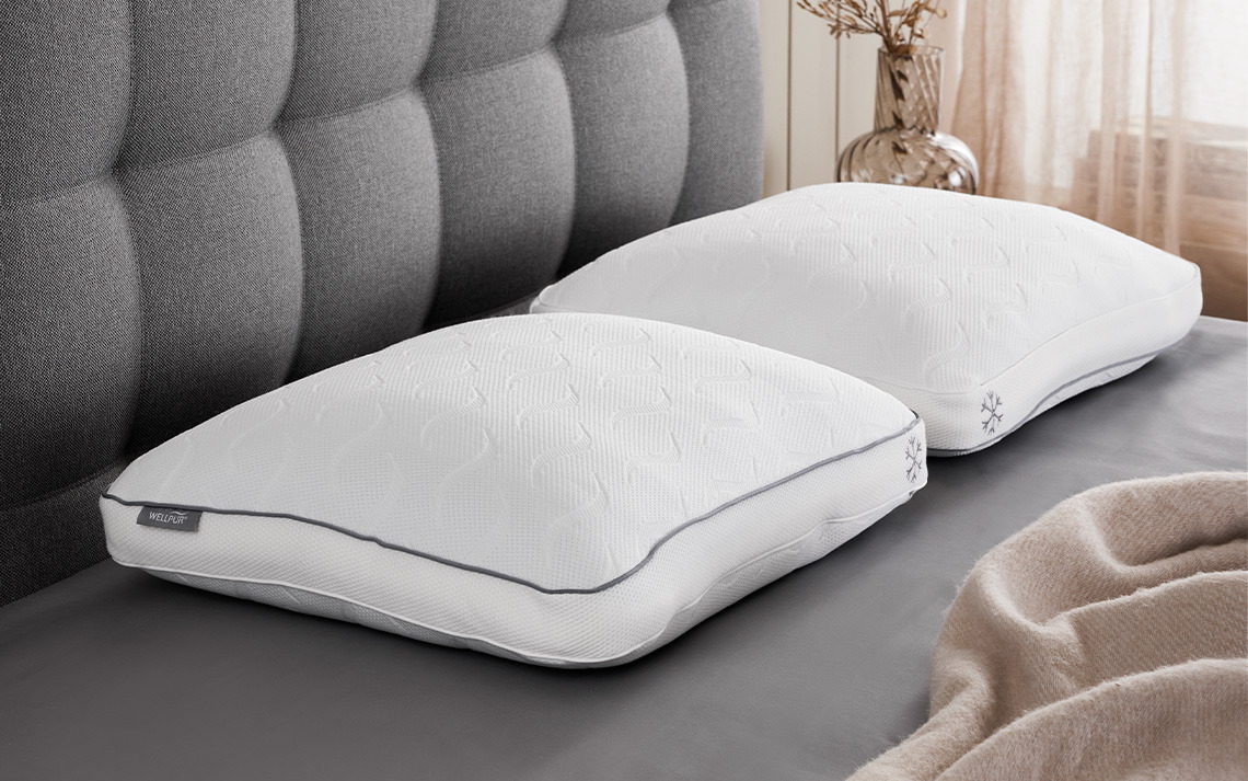 SOGNDAL memory foam pillow with cooling gel layer and cooling cover Cooling pillows with shredded memory foam, cooling gel layer, and cooling cover on bed