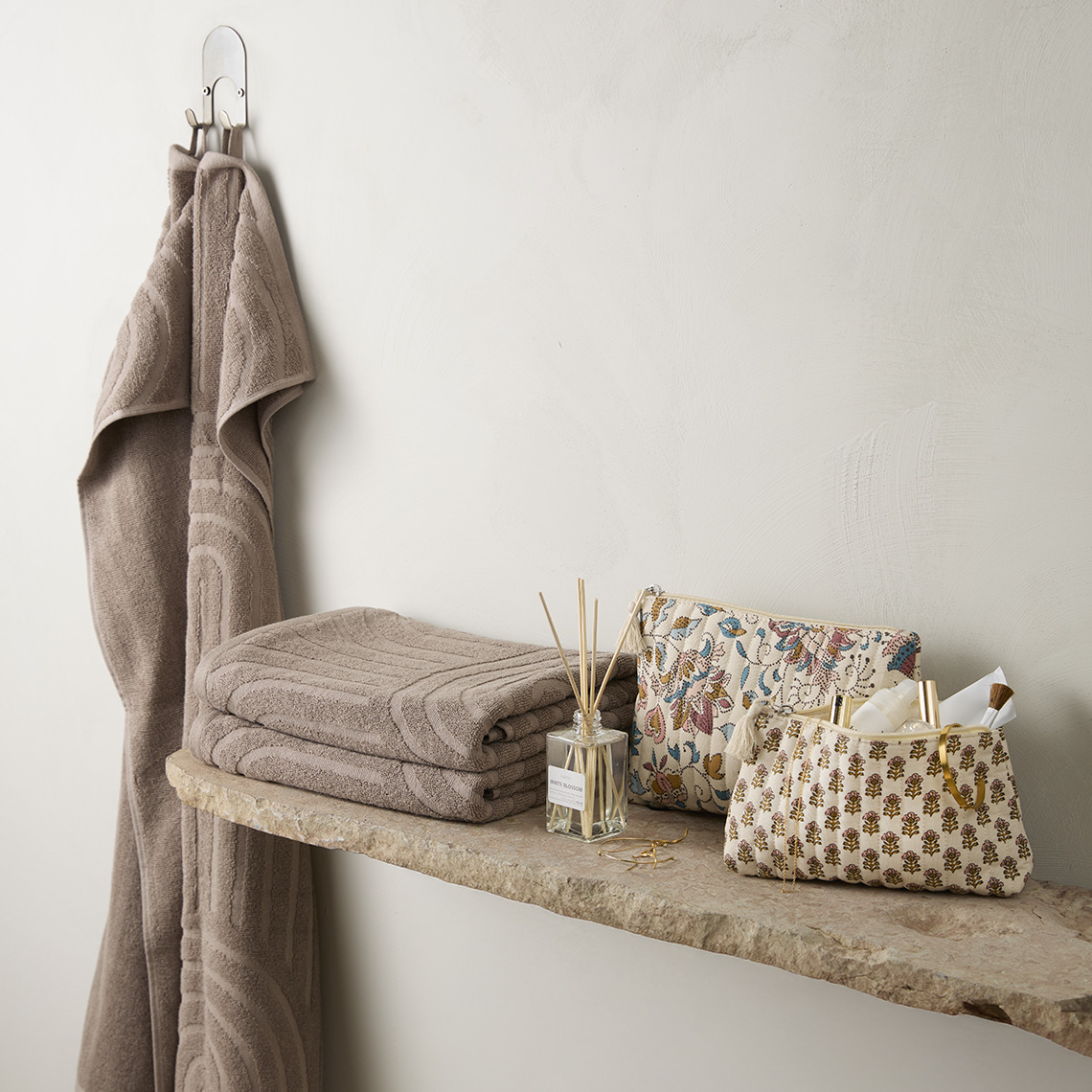 Towels and toilet bags on a shelf