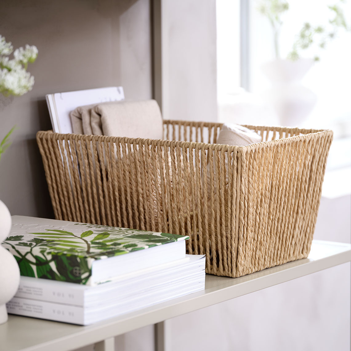 The LARSEMIL basket has an airy and soft appearance due to the braided paper strands Decorative basket made with braided paper strands